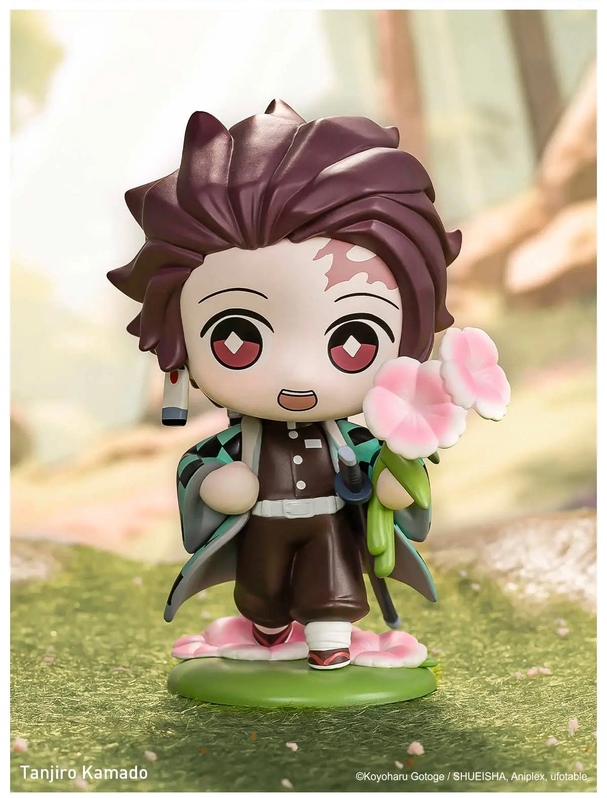 Figurine of Tanjiro Kamado holding flowers on a blurred natural background, POPMART Demon Slayer Figures blind box