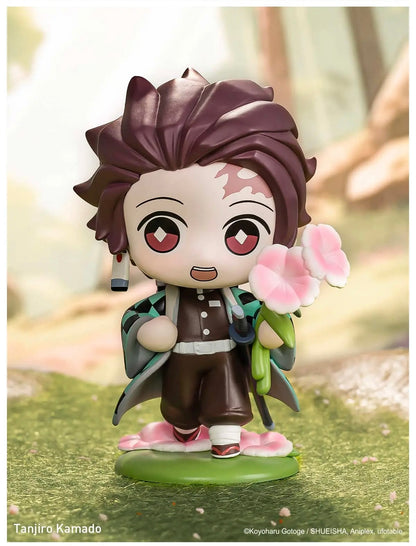 Figurine of Tanjiro Kamado holding flowers on a blurred natural background, POPMART Demon Slayer Figures blind box