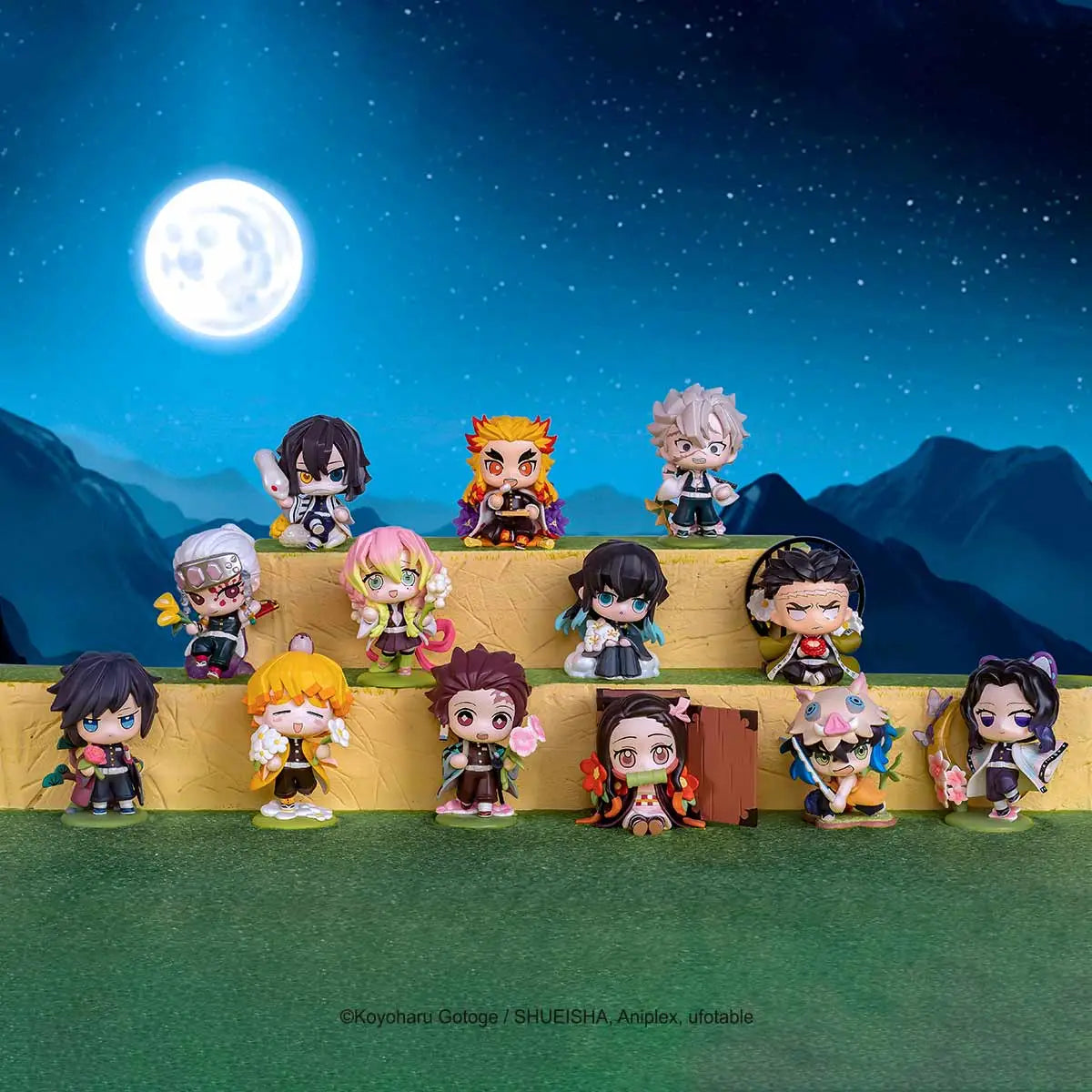 Collection of anime POPMART Demon Slayer: Kimetsu no Yaiba Birth Flower Series Figures blind box with a night sky and moon in the background