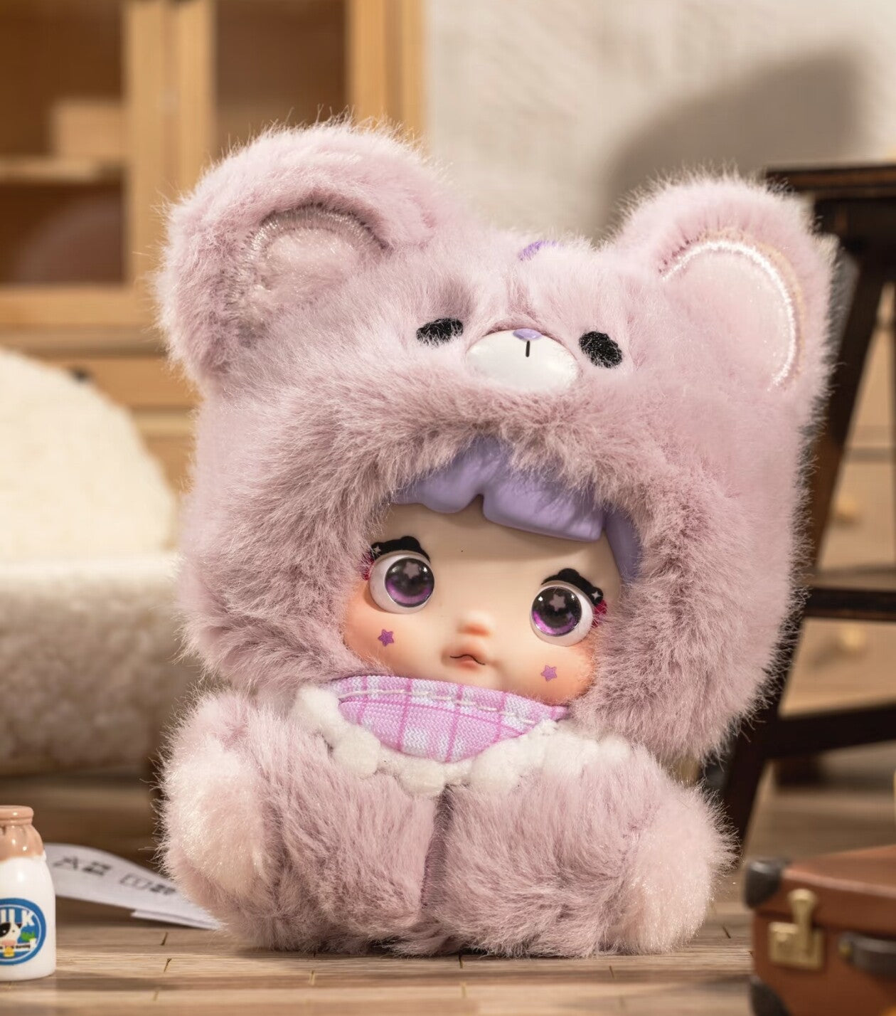 Plush toy with a hood resembling a bear, sitting on a surface. Nommi V4 Baby Series plush key chain blind box — Berry Baby (lavender/purple) — Kuwait — نومي — Maibo