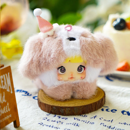Small plush toy with a fluffy brown and white hood on a wooden base. Nommi V4 Baby Series plush key chain blind box — Cherry Baby (pink) — Kuwait — نومي — Maibo