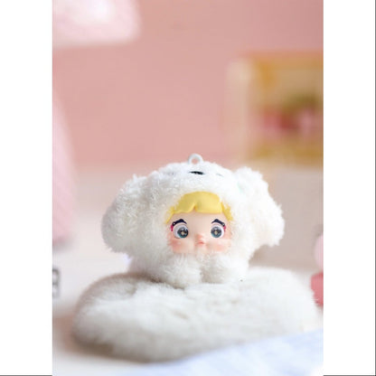 Small plush toy with a white outfit and yellow hair on a pink background, Nommi V4 Baby Series plush key chain blind box — Creamy Baby white — Kuwait — نومي — Maibo