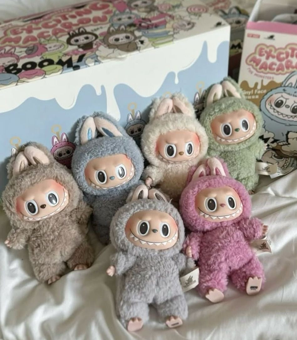 Pop Mart Labubu the monsters Exciting Macaron V1 blind box — full lineup (Soymilk, Lychee Berry, Green Grape, Sea Salt Coconut, Sesame Bean, Toffee, Chestnut Cocoa Secret) — Kuwait — ماكرون لابوبو الاصدار الاول next to box